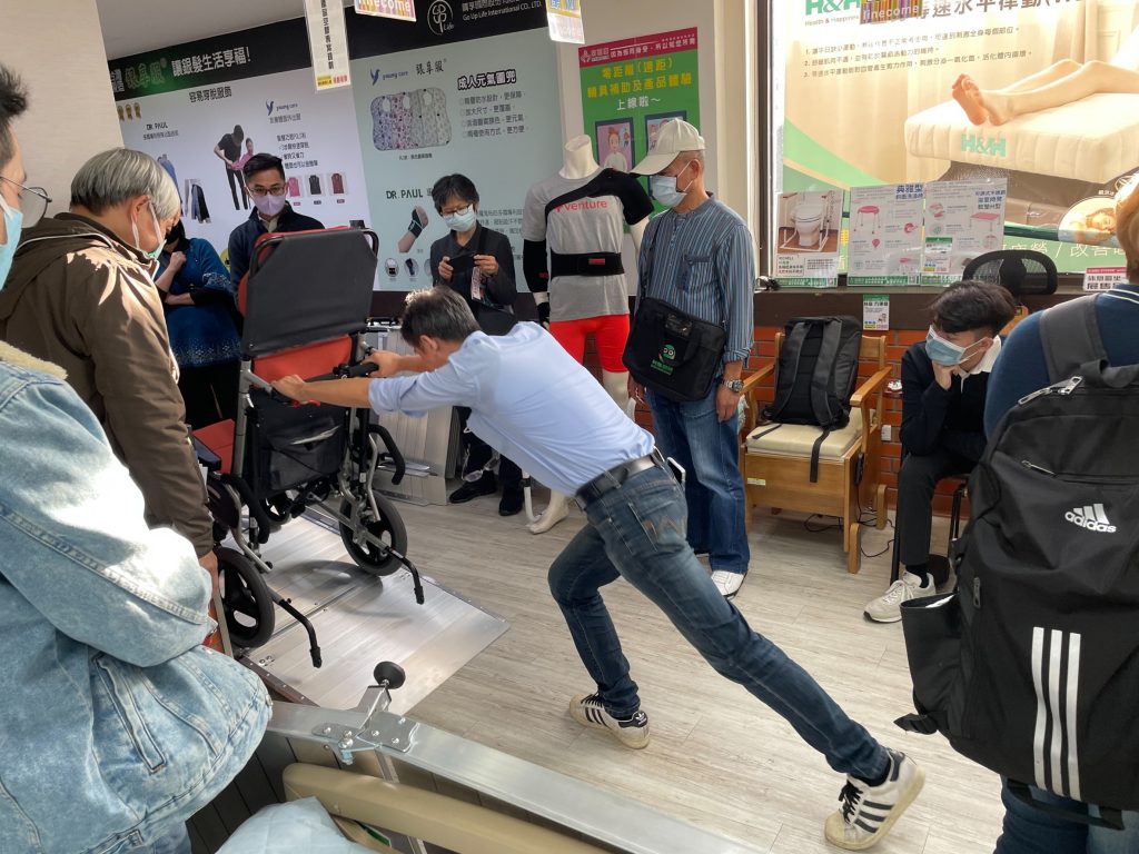 Demonstration of correct posture for pushing a wheelchair up and down ramp